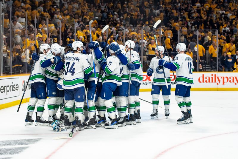 May 3, 2024; Nashville, Tennessee, USA; Vancouver Canucks celebrate the win against the Nashville Predators during game six of the first round of the 2024 Stanley Cup Playoffs at Bridgestone Arena. Mandatory Credit: Steve Roberts-USA TODAY Sports