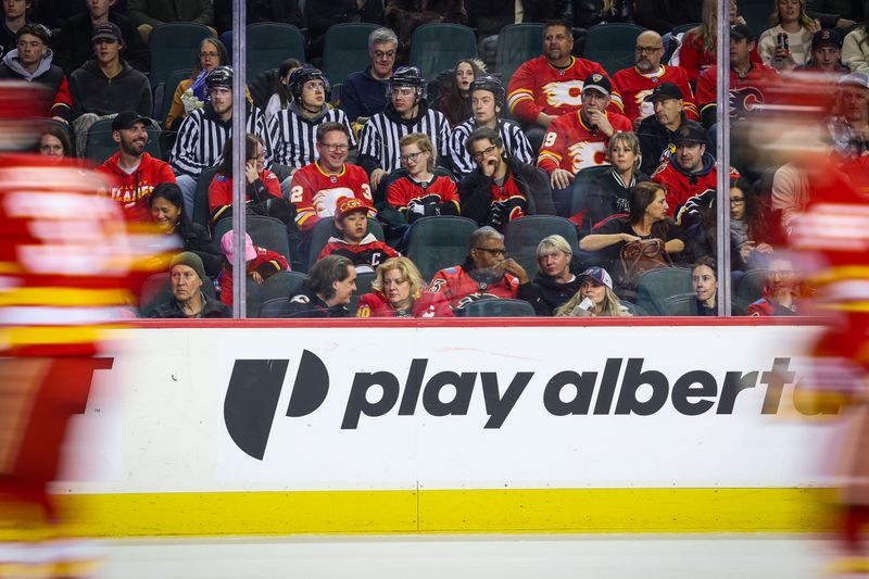 Jan 23, 2026; Calgary, Alberta, CAN; Fans dressed as referees in the stands during the first period between the Calgary Flames and the Washington Capitals at Scotiabank Saddledome. Mandatory Credit: Sergei Belski-Imagn Images