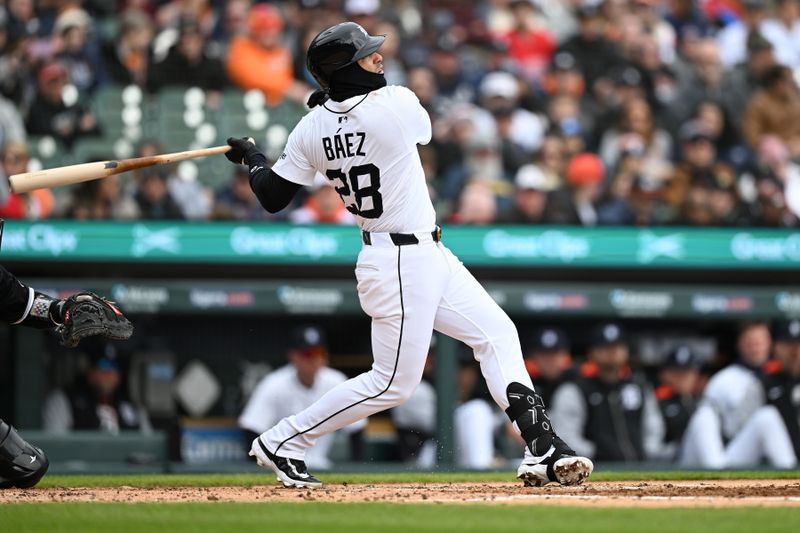 Apr 6, 2025; Detroit, Michigan, USA; Detroit Tigers shortstop Javier Báez (28) hits an RBI single against the Chicago White Sox in the second inning at Comerica Park. Mandatory Credit: Lon Horwedel-Imagn Images