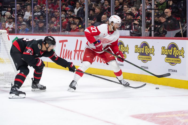 Dec 5, 2024; Ottawa, Ontario, CAN; Ottawa Senators defenseman Travis Hamonic (23) and Detroit Red Wings center Michael Rasmussen (27) chase the puck in the second period at the Canadian Tire Centre. Mandatory Credit: Marc DesRosiers-Imagn Images