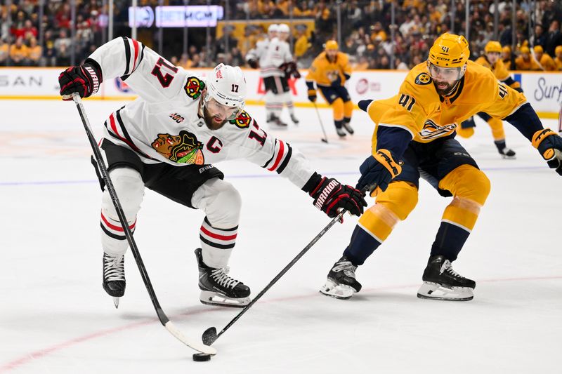 Jan 10, 2026; Nashville, Tennessee, USA;  Chicago Blackhawks left wing Nick Foligno (17) and Nashville Predators defenseman Nicolas Hague (41) battle for the puck during the second period at Bridgestone Arena. Mandatory Credit: Steve Roberts-Imagn Images