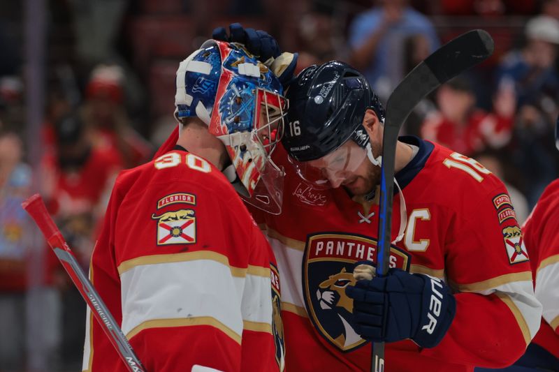 Nov 30, 2024; Sunrise, Florida, USA; Florida Panthers goaltender Spencer Knight (30) celebrates with center Aleksander Barkov (16) after the game against the Carolina Hurricanes at Amerant Bank Arena. Mandatory Credit: Sam Navarro-Imagn Images