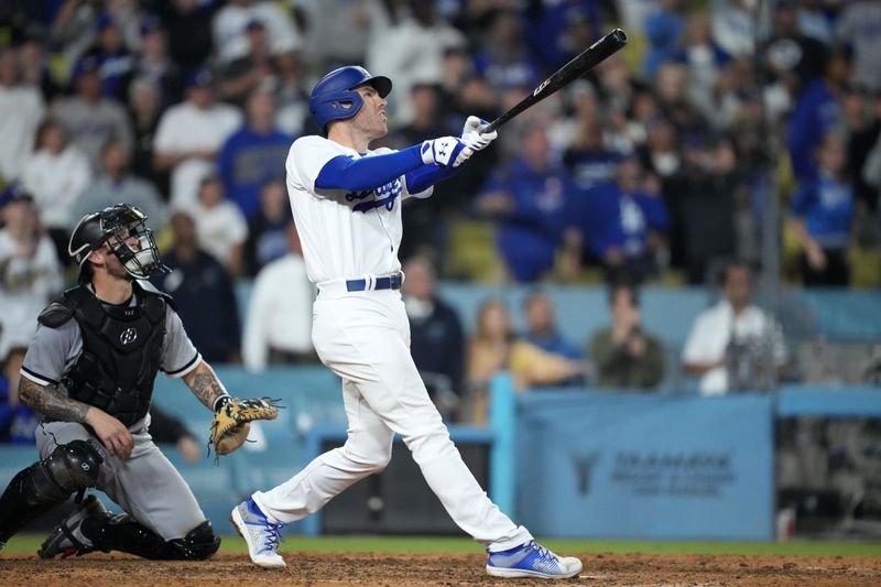 Jun 15, 2023; Los Angeles, California, USA; Los Angeles Dodgers first baseman Freddie Freeman (5) follows through on a walk-off single in the 11th inning as Chicago White Sox catcher Yasmani Grandal (24) watches at Dodger Stadium. Mandatory Credit: Kirby Lee-USA TODAY Sports