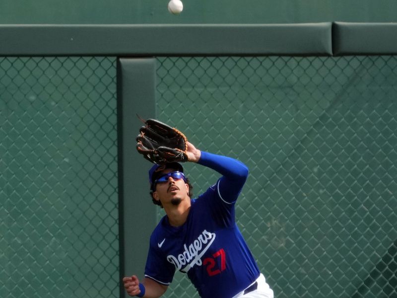 Feb 25, 2024; Phoenix, Arizona, USA; Los Angeles Dodgers left fielder Miguel Vargas (27) gets under a fly ball against the Oakland Athletics during the third inning at Camelback Ranch-Glendale. Mandatory Credit: Joe Camporeale-USA TODAY Sports