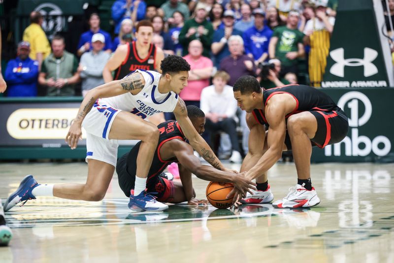 Jan 30, 2024; Fort Collins, Colorado, USA; Colorado State Rams guard Nique Clifford (10) fights for a loose ball with San Diego State Aztecs forward Jaedon LeDee (13) and guard Lamont Butler (5) during the first half at Moby Arena. Mandatory Credit: Chet Strange-USA TODAY Sports