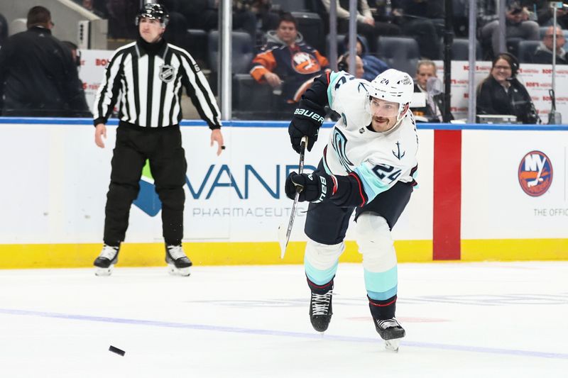 Nov 23, 2025; Elmont, New York, USA;  Seattle Kraken defenseman Jamie Oleksiak (24) attempts a shot on goal in the second period against the New York Islanders at UBS Arena. Mandatory Credit: Wendell Cruz-Imagn Images