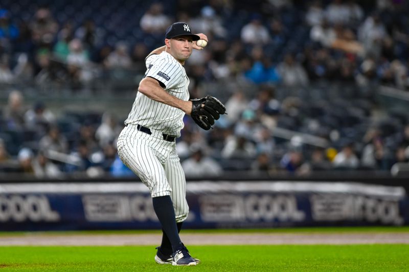 Sep 29, 2024; Bronx, New York, USA; New York Yankees pitcher Tim Mayza (58) fields a ground ball and throws to first base for an out against the Pittsburgh Pirates during the seventh inning at Yankee Stadium. Mandatory Credit: John Jones-Imagn Images