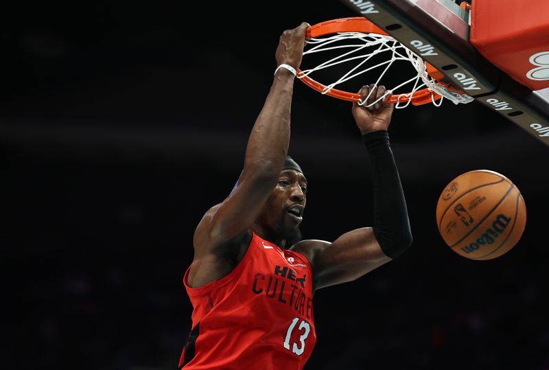 CHARLOTTE, NORTH CAROLINA - NOVEMBER 27: Bam Adebayo #13 of the Miami Heat dunks the ball during the second half of the game against the Charlotte Hornets at Spectrum Center on November 27, 2024 in Charlotte, North Carolina. NOTE TO USER: User expressly acknowledges and agrees that, by downloading and or using this photograph, User is consenting to the terms and conditions of the Getty Images License Agreement. (Photo by Jared C. Tilton/Getty Images)