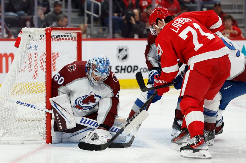 Feb 22, 2024; Detroit, Michigan, USA;  Colorado Avalanche goaltender Justus Annunen (60) makes a save on Detroit Red Wings center Dylan Larkin (71) in the second period at Little Caesars Arena. Mandatory Credit: Rick Osentoski-USA TODAY Sports