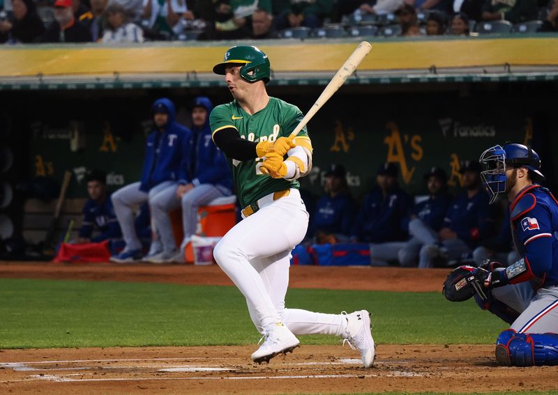 Sep 25, 2024; Oakland, California, USA; Oakland Athletics designated hitter Brent Rooker (25) hits a single against the Texas Rangers during the first inning at Oakland-Alameda County Coliseum. Mandatory Credit: Kelley L Cox-Imagn Images