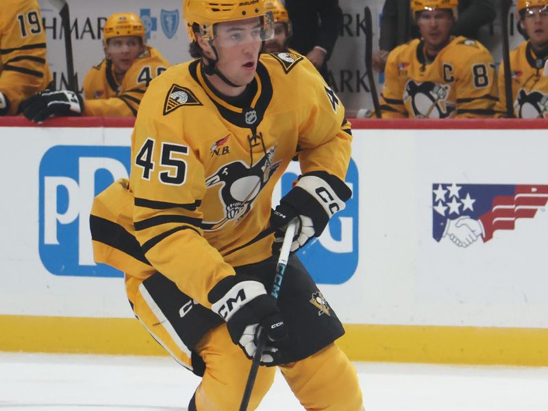 Oct 9, 2025; Pittsburgh, Pennsylvania, USA;  Pittsburgh Penguins defenseman Harrison Brunicke (45) skates with the puck against the New York Islanders during the first period at PPG Paints Arena. Mandatory Credit: Charles LeClaire-Imagn Images