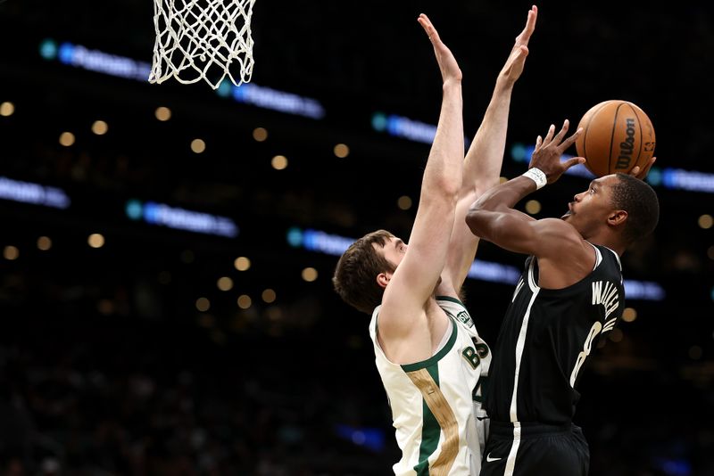 BOSTON, MASSACHUSETTS - NOVEMBER 10: Lonnie Walker IV #8 of the Brooklyn Nets takes a shot against Luke Kornet #40 of the Boston Celtics  during the second hafl of their In-Season Tournament game at TD Garden on November 10, 2023 in Boston, Massachusetts. The Celtics defeat the Nets 121-107. NOTE TO USER: User expressly acknowledges and agrees that, by downloading and or using this photograph, User is consenting to the terms and conditions of the Getty Images License Agreement. (Photo by Maddie Meyer/Getty Images)