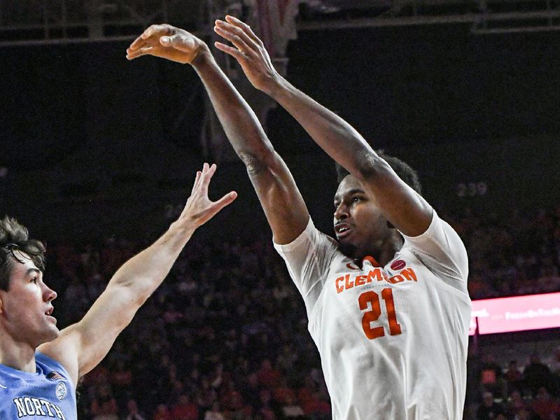 Jan 6, 2024; Clemson, South Carolina, USA; Clemson sophomore forward Chauncey Wiggins (21) shoots over University of North Carolina guard Cormac Ryan (3) during the first half at Littlejohn Coliseum. Mandatory Credit: Ken Ruinard-USA TODAY Sports