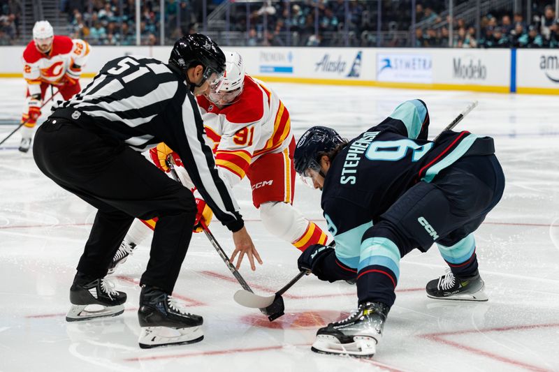 Oct 19, 2024; Seattle, Washington, USA; Calgary Flames center Nazem Kadri (91) and Seattle Kraken center Chandler Stephenson (9) face off during the second period at Climate Pledge Arena. Mandatory Credit: Caean Couto-Imagn Images