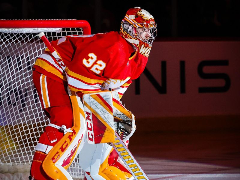 Apr 12, 2023; Calgary, Alberta, CAN; Calgary Flames goaltender Dustin Wolf (32) in his net prior to the game against the San Jose Sharks at Scotiabank Saddledome. Mandatory Credit: Sergei Belski-USA TODAY Sports