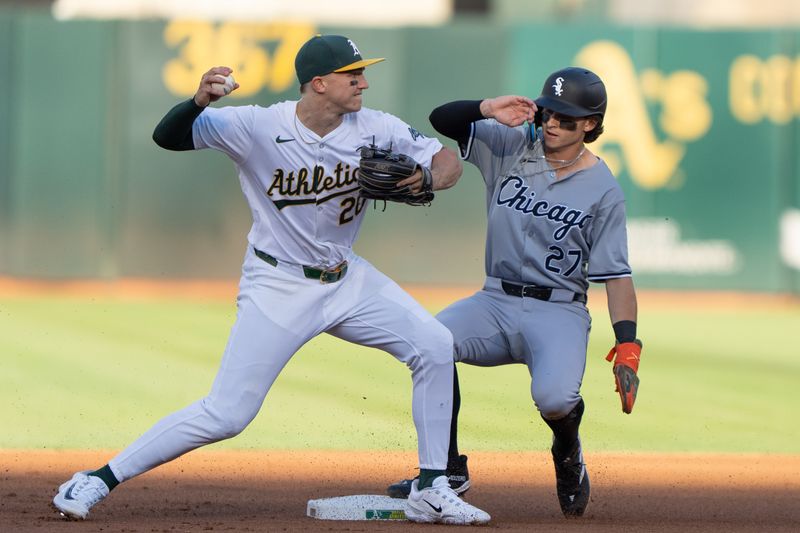 Aug 6, 2024; Oakland, California, USA;  Oakland Athletics second base Zack Gelof (20) attempts a double play during the first inning against Chicago White Sox shortstop Brooks Baldwin (27) at Oakland-Alameda County Coliseum. Mandatory Credit: Stan Szeto-USA TODAY Sports