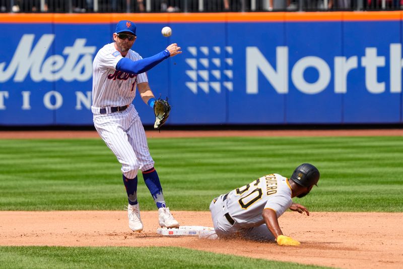 Aug 16, 2023; New York City, New York, USA; New York Mets second baseman Jeff McNeil (1) turns a double play with Pittsburgh Pirates second baseman Liover Peguero (60) sliding into second base during the second inning at Citi Field. Mandatory Credit: Gregory Fisher-USA TODAY Sports