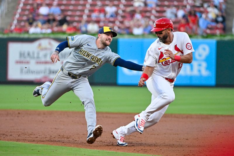 Aug 21, 2024; St. Louis, Missouri, USA;  Milwaukee Brewers second baseman Brice Turang (2) tags out St. Louis Cardinals designated hitter Matt Carpenter (13) to end the second inning at Busch Stadium. Mandatory Credit: Jeff Curry-USA TODAY Sports