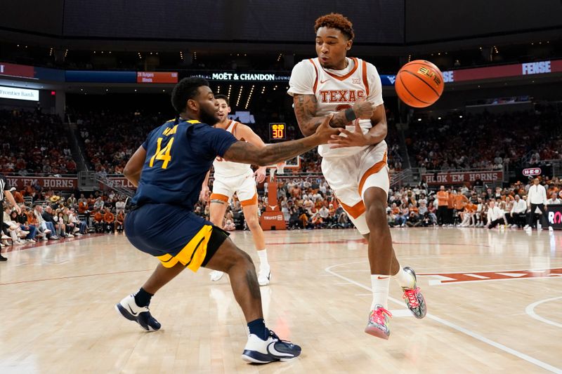 Feb 11, 2023; Austin, Texas, USA; Texas Longhorns guard Arterio Morris (2) and West Virginia Mountaineers guard Seth Wilson (14) reach for the loose ball during the second half at Moody Center. Mandatory Credit: Scott Wachter-USA TODAY Sports