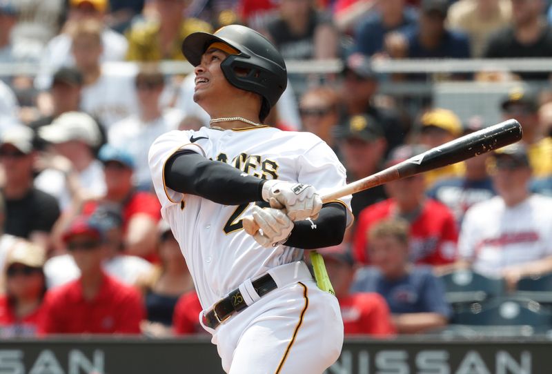 Jul 19, 2023; Pittsburgh, Pennsylvania, USA;  Pittsburgh Pirates catcher Endy Rodriguez (25) hits a single to record the first major league hit of his career against the Cleveland Guardians during the seventh inning at PNC Park. Mandatory Credit: Charles LeClaire-USA TODAY Sports