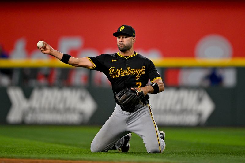 Aug 21, 2024; Arlington, Texas, USA; Pittsburgh Pirates second baseman Isiah Kiner-Falefa (7) throws from his knees but cannot put out Texas Rangers catcher Jonah Heim (not pictured) during the ninth inning at Globe Life Field. Mandatory Credit: Jerome Miron-USA TODAY Sports