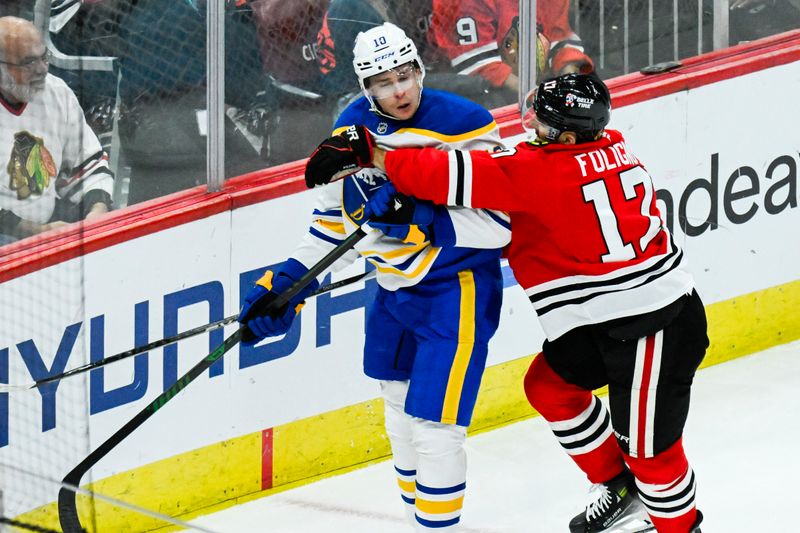 Oct 19, 2024; Chicago, Illinois, USA;  Chicago Blackhawks left wing Nick Foligno (17) and Buffalo Sabres defenseman Henri Jokiharju (10) during the third period at the United Center. Mandatory Credit: Matt Marton-Imagn Images