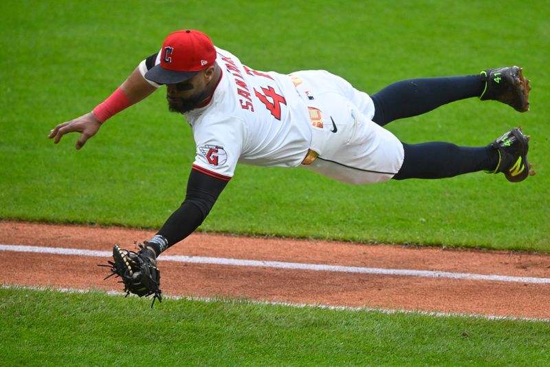 Jun 10, 2025; Cleveland, Ohio, USA; Cleveland Guardians first baseman Carlos Santana (41) dives while catching a foul ball in the fifth inning against the Cincinnati Reds at Progressive Field. Mandatory Credit: David Richard-Imagn Images