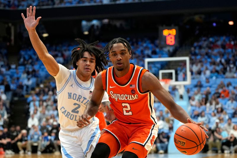 Jan 13, 2024; Chapel Hill, North Carolina, USA; Syracuse Orange guard JJ Starling (2) with the ball as North Carolina Tar Heels guard Elliot Cadeau (2) defends in the first half at Dean E. Smith Center. Mandatory Credit: Bob Donnan-USA TODAY Sports