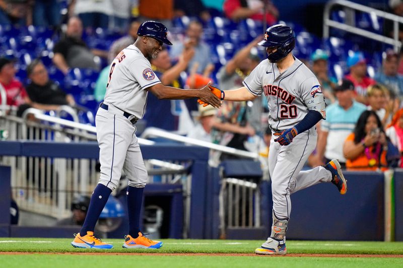 Aug 16, 2023; Miami, Florida, USA; Houston Astros center fielder Chas McCormick (20) celebrates with Houston Astros third base coach Gary Pettis (8) after hitting a home run against the Miami Marlins during the first inning at loanDepot Park. Mandatory Credit: Rich Storry-USA TODAY Sports