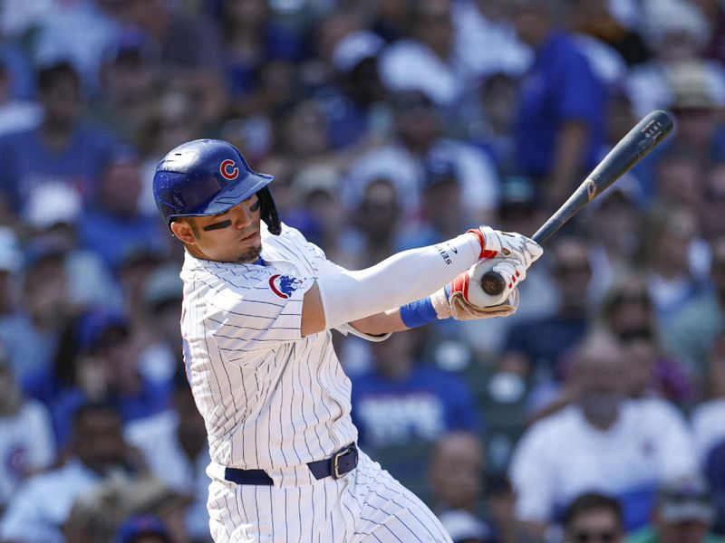 Sep 18, 2024; Chicago, Illinois, USA; Chicago Cubs outfielder Seiya Suzuki (27) hits an RBI-single against the Oakland Athletics during the fifth inning at Wrigley Field. Mandatory Credit: Kamil Krzaczynski-Imagn Images