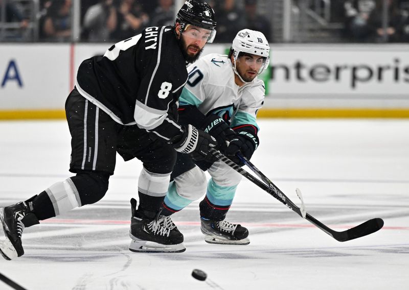 Oct 13, 2022; Los Angeles, California, USA; Los Angeles Kings defenseman Drew Doughty (8) and Seattle Kraken center Matty Beniers (10) battle for the puck in the third period at Crypto.com Arena. Mandatory Credit: Jayne Kamin-Oncea-USA TODAY Sports