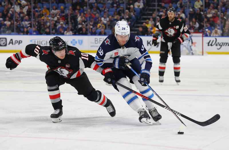 Mar 3, 2024; Buffalo, New York, USA;  Buffalo Sabres defenseman Henri Jokiharju (10) and Winnipeg Jets center Morgan Barron (36) go after the puck during the first period at KeyBank Center. Mandatory Credit: Timothy T. Ludwig-USA TODAY Sports