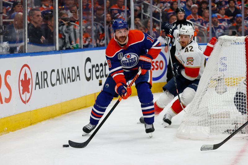 Jun 13, 2024; Edmonton, Alberta, CAN; Edmonton Oilers left wing Zach Hyman (18) plays the puck in the second period against the Florida Panthers in game three of the 2024 Stanley Cup Final at Rogers Place. Mandatory Credit: Perry Nelson-USA TODAY Sports