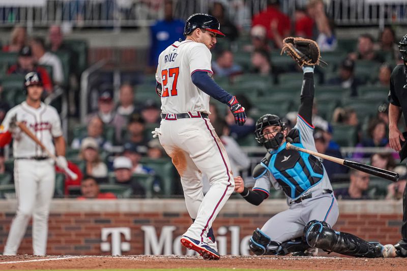 Apr 23, 2024; Cumberland, Georgia, USA; Atlanta Braves third base Austin Riley (27) reacts after being hit by a pitch against the Miami Marlins during the seventh inning at Truist Park. Mandatory Credit: Dale Zanine-USA TODAY Sports