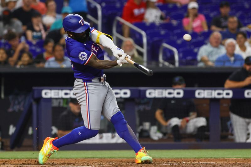 Jun 2, 2024; Miami, Florida, USA; Texas Rangers right fielder Adolis Garcia (53) hits a home run against the Miami Marlins during the sixth inning at loanDepot Park. Mandatory Credit: Sam Navarro-USA TODAY Sports