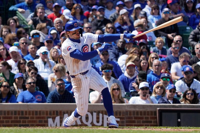 Apr 21, 2024; Chicago, Illinois, USA; Chicago Cubs second baseman Nico Hoerner (2) hits a one RBI single against the Miami Marlins during the second inning at Wrigley Field. Mandatory Credit: David Banks-USA TODAY Sports