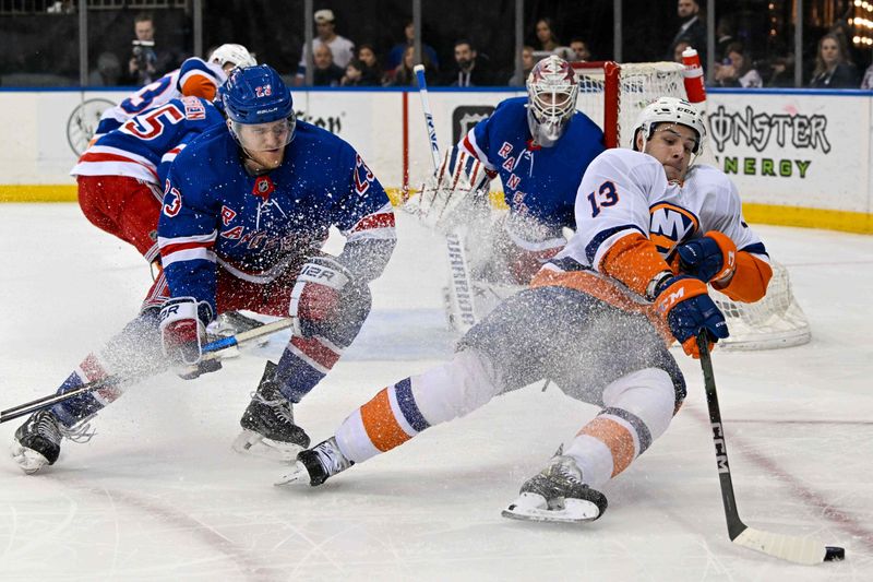 Apr 13, 2024; New York, New York, USA;  New York Islanders center Mathew Barzal (13) falls while skating with the puck defended by New York Rangers defenseman Adam Fox (23) during the first period at Madison Square Garden. Mandatory Credit: Dennis Schneidler-USA TODAY Sports