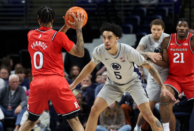 Feb 18, 2026; University Park, Pennsylvania, USA; Penn State Nittany Lions guard Freddie Dilione V (5) defends as Rutgers Scarlet Knights guard Tariq Francis (0) holds the ball during the first half at Bryce Jordan Center. Mandatory Credit: Matthew O'Haren-Imagn Images