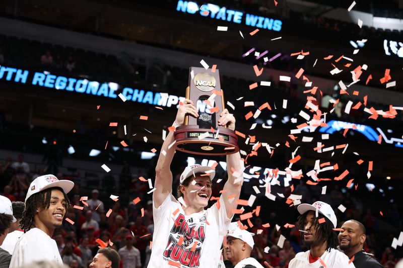 Mar 31, 2024; Dallas, TX, USA; North Carolina State Wolfpack forward Ben Middlebrooks (34) celebrates with the trophy after defeating the Duke Blue Devils in the finals of the South Regional of the 2024 NCAA Tournament at American Airline Center. Mandatory Credit: Kevin Jairaj-USA TODAY Sports