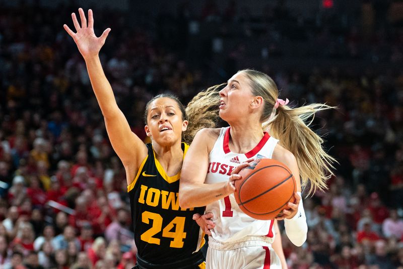 Feb 11, 2024; Lincoln, Nebraska, USA; Nebraska Cornhuskers guard Jaz Shelley (1) drives against Iowa Hawkeyes guard Gabbie Marshall (24) during the first quarter at Pinnacle Bank Arena. Mandatory Credit: Dylan Widger-USA TODAY Sports