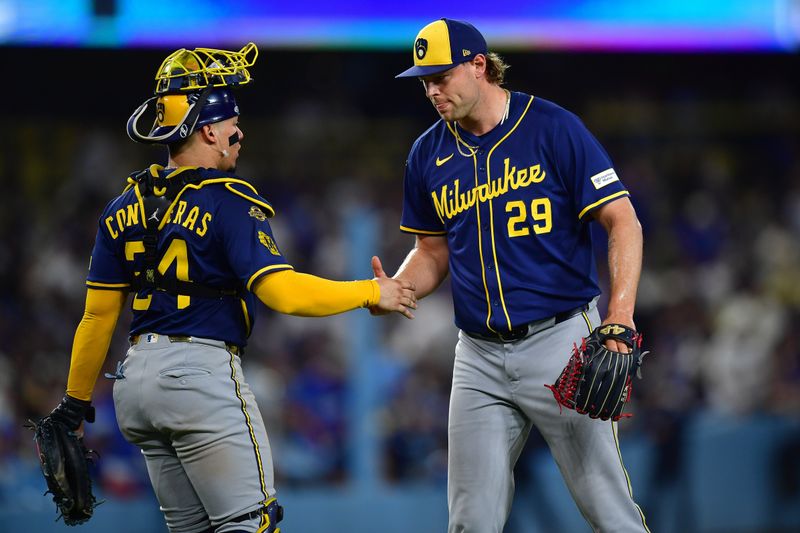 Jul 18, 2025; Los Angeles, California, USA; Milwaukee Brewers catcher William Contreras (24) and pitcher Trevor Megill (29) celebrate the victory against the Los Angeles Dodgers at Dodger Stadium. Mandatory Credit: Gary A. Vasquez-Imagn Images