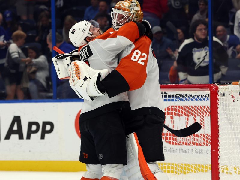 Nov 7, 2024; Tampa, Florida, USA; Philadelphia Flyers right wing Travis Konecny (11) and goaltender Ivan Fedotov (82) celebrate after defeating the Tampa Bay Lightning at Amalie Arena. Mandatory Credit: Kim Klement Neitzel-Imagn Images