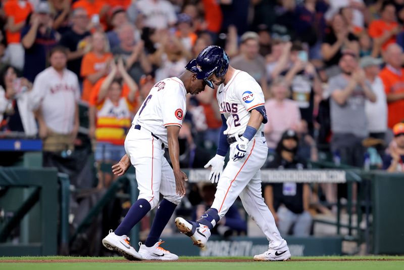 May 14, 2024; Houston, Texas, USA; Houston Astros third baseman Alex Bregman (2) celebrates with Houston Astros third base coach Gary Pettis (8) after hitting a solo home run to left field against the Oakland Athletics during the second inning at Minute Maid Park. Mandatory Credit: Erik Williams-USA TODAY Sports