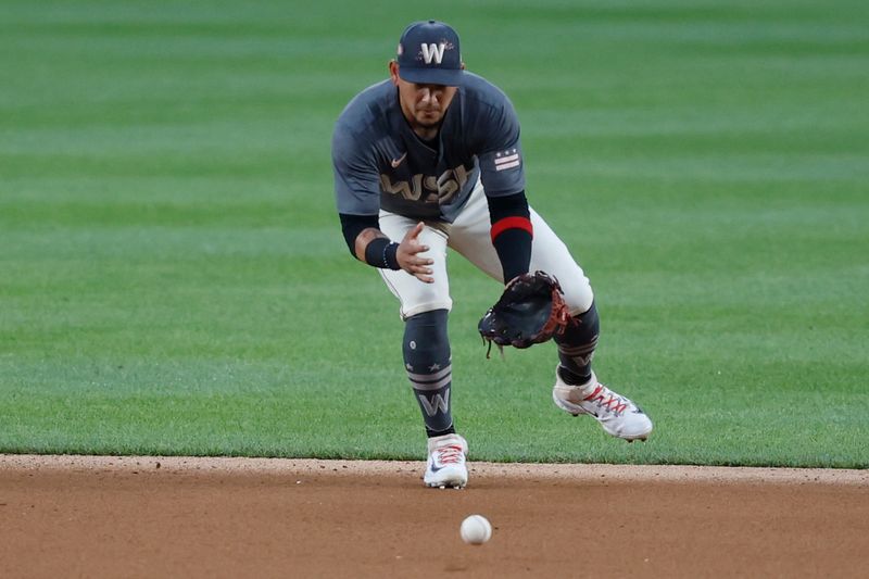 Jul 20, 2024; Washington, District of Columbia, USA; Washington Nationals second base Ildemaro Vargas (14) fields a ground ball by Cincinnati Reds third base Jeimer Candelario (not pictured) during the fourth inning at Nationals Park. Mandatory Credit: Geoff Burke-USA TODAY Sports