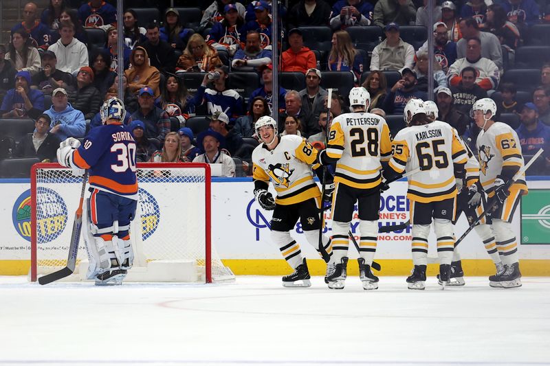 Nov 5, 2024; Elmont, New York, USA; Pittsburgh Penguins center Sidney Crosby (87) celebrates his goal against New York Islanders goaltender Ilya Sorokin (30) with teammates during the second period at UBS Arena. Mandatory Credit: Brad Penner-Imagn Images