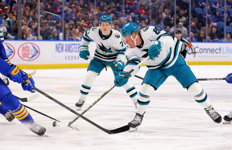 Mar 4, 2025; Buffalo, New York, USA;  San Jose Sharks left wing Fabian Zetterlund (20) takes a shot on goal during the first period against the Buffalo Sabres at KeyBank Center. Mandatory Credit: Timothy T. Ludwig-Imagn Images