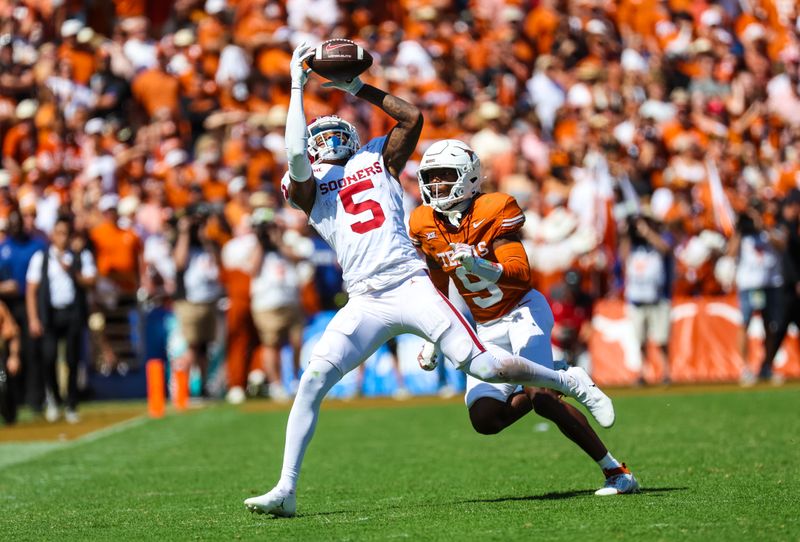 Oct 7, 2023; Dallas, Texas, USA;  Oklahoma Sooners wide receiver Andrel Anthony (5) makes a catch in front of Texas Longhorns defensive back Gavin Holmes (9) during the second half at the Cotton Bowl. Mandatory Credit: Kevin Jairaj-USA TODAY Sports