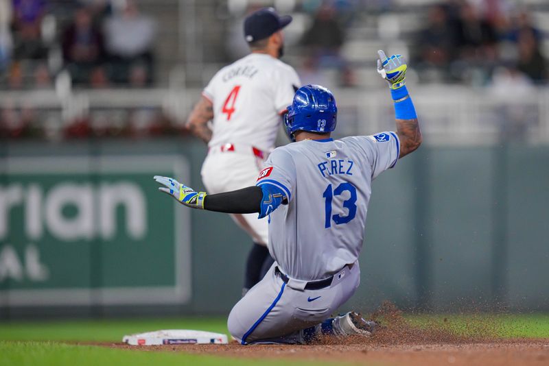 May 28, 2024; Minneapolis, Minnesota, USA; Kansas City Royals catcher Salvador Perez (13) doubles against the Minnesota Twins in the ninth inning at Target Field. Mandatory Credit: Brad Rempel-USA TODAY Sports