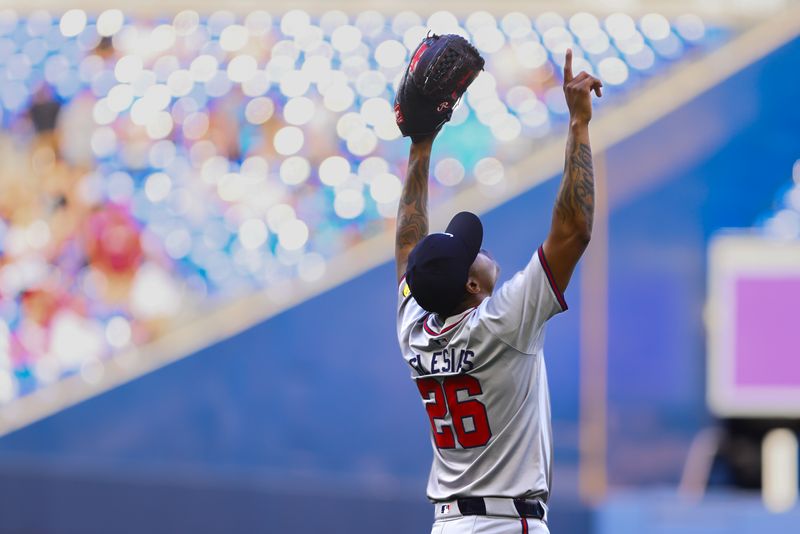 Apr 14, 2024; Miami, Florida, USA; Atlanta Braves relief pitcher Raisel Iglesias (26) celebrates after the game against the Miami Marlins at loanDepot Park. Mandatory Credit: Sam Navarro-USA TODAY Sports