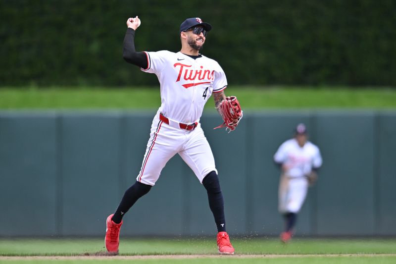 May 4, 2024; Minneapolis, Minnesota, USA; Minnesota Twins shortstop Carlos Correa (4) makes a putout during the sixth inning against the Boston Red Sox at Target Field. Mandatory Credit: Jeffrey Becker-USA TODAY Sports